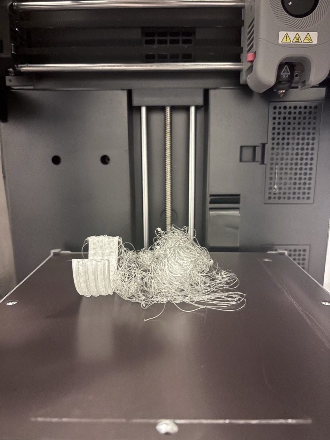 A failed TPU tire print collapsed into loose strands on the bed